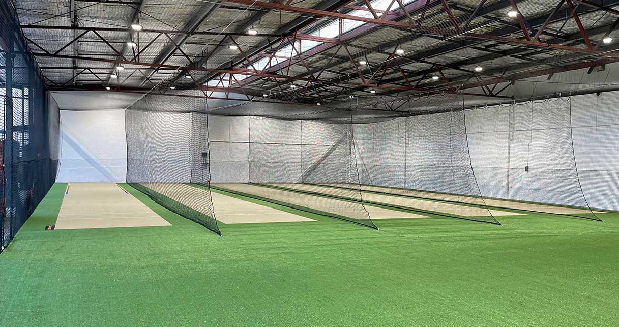 Four netted indoor cricket lanes with turf and wicket surfaces after conversion